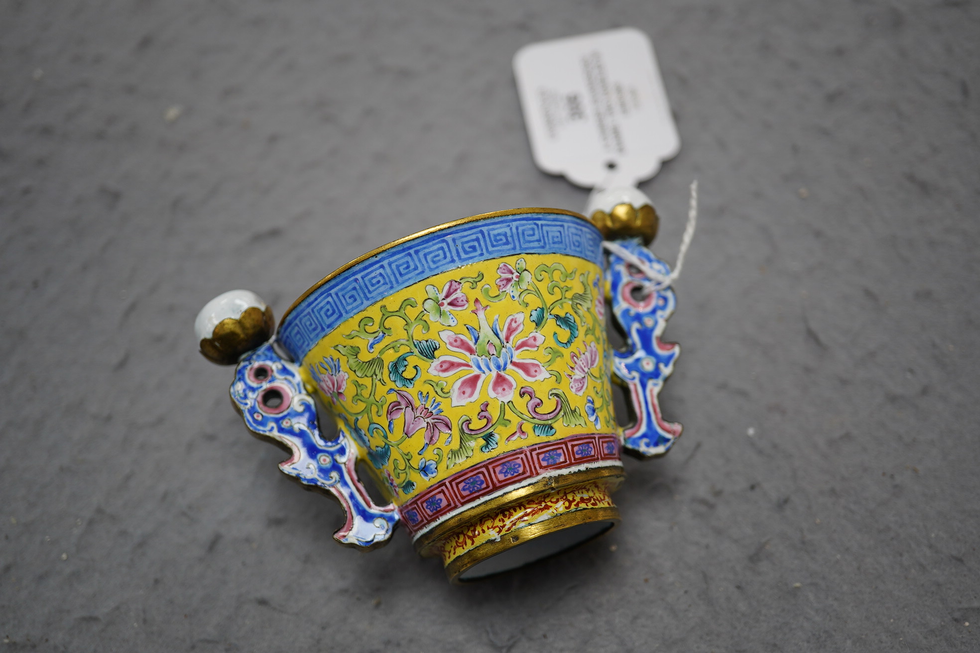 A Chinese Guangzhou enamel two handled wine cup, four character Qianlong mark and of the period (1736-1795)